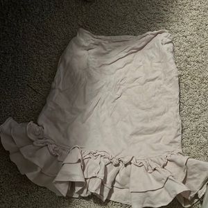 Light pink fitting skirt with ruffles at the end.